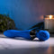 Selopa Blue Belle Double-Ended Vibrator with Dual Motors and 7 Speeds on a Marble Surface with Candle Background