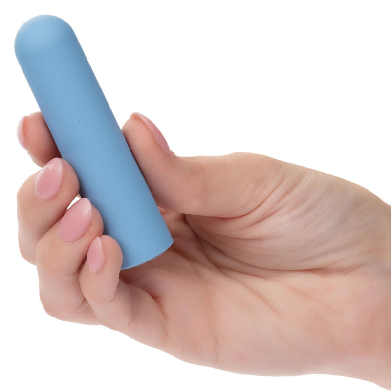 Hand holding the blue Turbo Buzz™ Rounded Bullet Vibrator - 10-function discreet and powerful mini stimulator.
