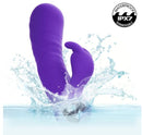 Extra Thicc Chubby Deep Thrust Bunny Rabbit Vibrator Purple splashing in water, showcasing waterproof design.