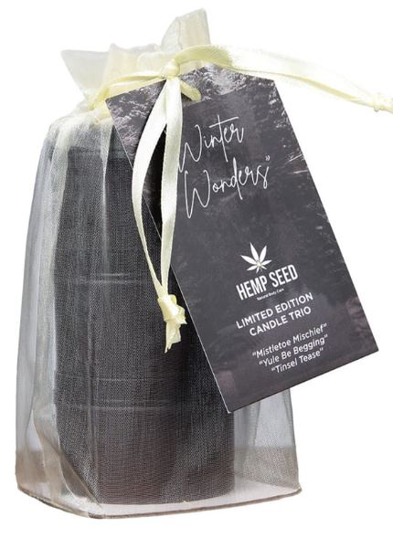 Earthly Body Hemp Seed 3-in-1 Massage Candle Holiday Trio gift set with festive packaging and tags.