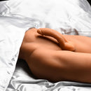 JOCK Male Sex Partner Doll with Thrusting Dildo resting on satin sheets, showcasing realistic lower body details.