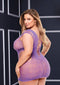 Plus-size model wearing purple sheer lace and fishnet mini dress with corset front, showcasing curves and cap sleeves against a dark backdrop.
