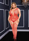 Red corset front suspender fishnet bodystocking with lace detail and cap sleeves, showcasing a bold and seductive design.