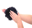 Person wearing blue faux fur sensory glove with hidden gold spikes for tactile play.