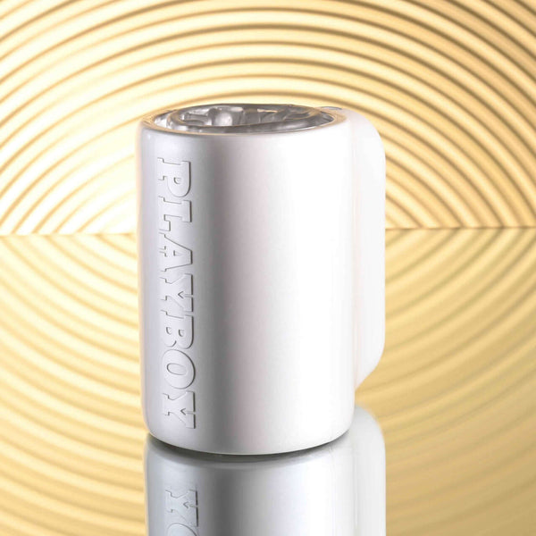 PLAYBOY Spin Doctor Dual Entry Stroker in sleek black and pearl finish against a stylish, golden textured background.