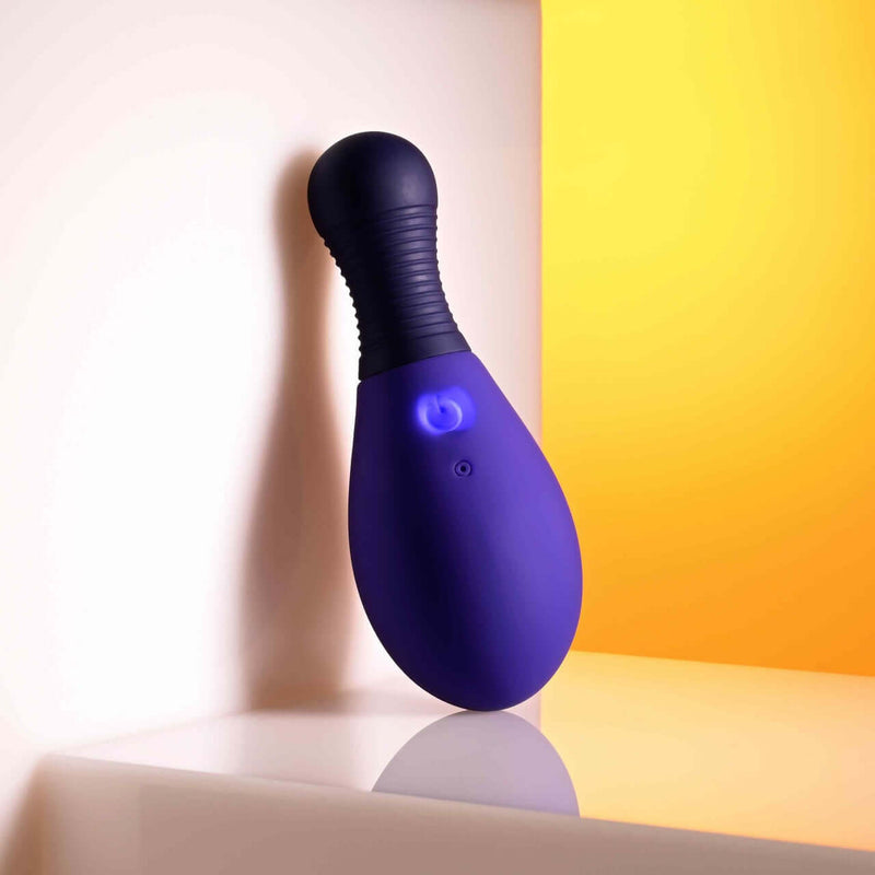 Selopa Egg Me On remote control vibrating egg with textured handle and 12 speeds in purple against a yellow and white background