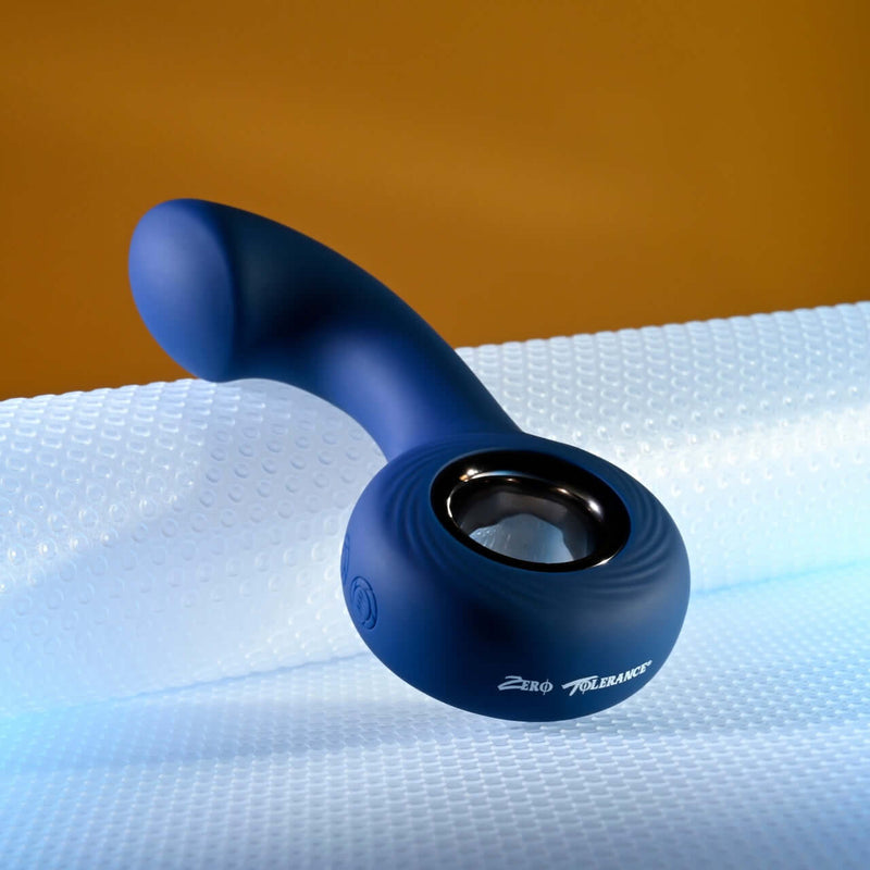 Zero Tolerance The Reach Vibrating P-Spot Plug with ringed handle on textured surface