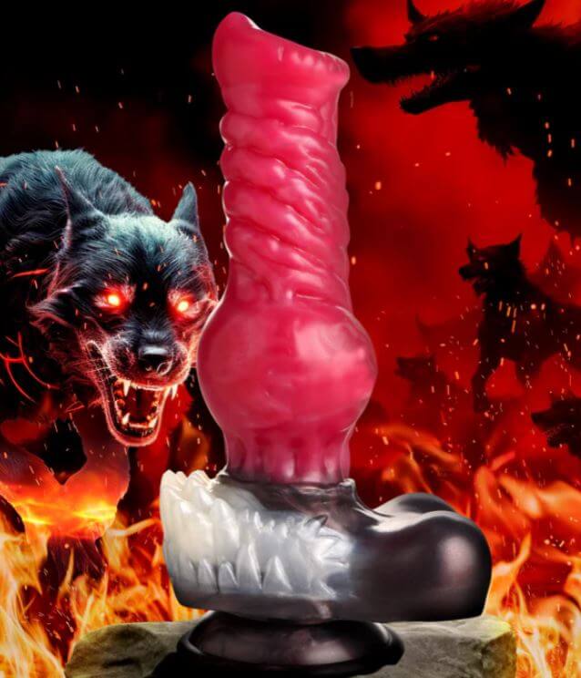 Fantasy red silicone dildo with canine design, featuring textured shaft, knot, and fur base in front of fiery background with snarling wolves.