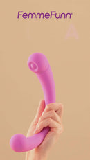 FemmeFunn Aluna Dual Stimulating Arc Vibrator Pink held in hand against a soft backdrop.