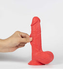 Get Lucky Real Skin Mr Ruby 7.5 Inch Dual Layer Dildo Red held in hand, showcasing its realistic design and texture.