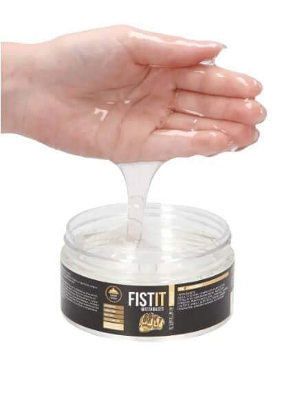 Fist It Water-based Fisting Glide in a hand, showcasing its smooth, long-lasting lubricant consistency.
