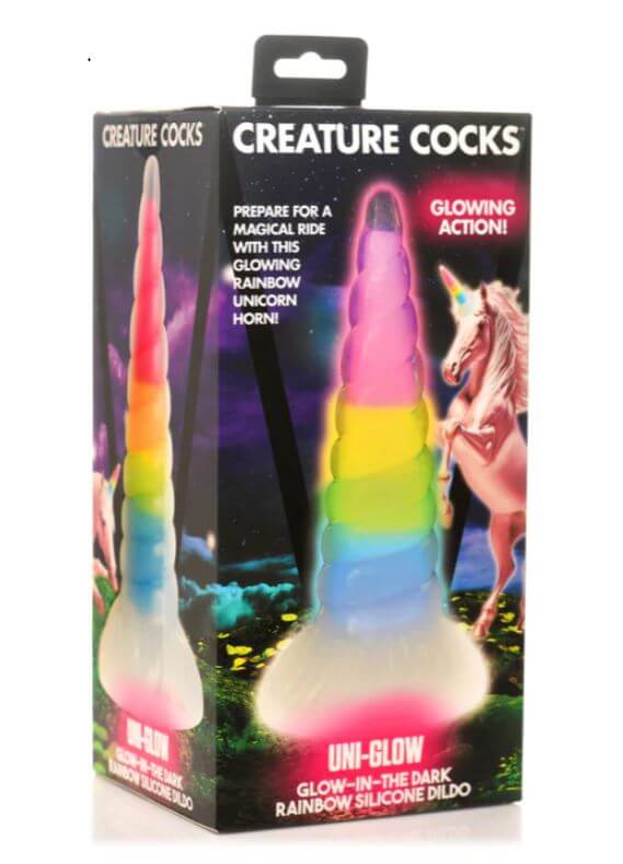 CREATURE COCKS Uni-Glow Glow in the Dark Rainbow Dildo in packaging featuring a unicorn and glowing rainbow design.