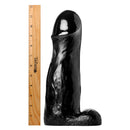 Master Cock The ManOlith 11 Inch Huge Dildo Black next to a ruler for size comparison.
