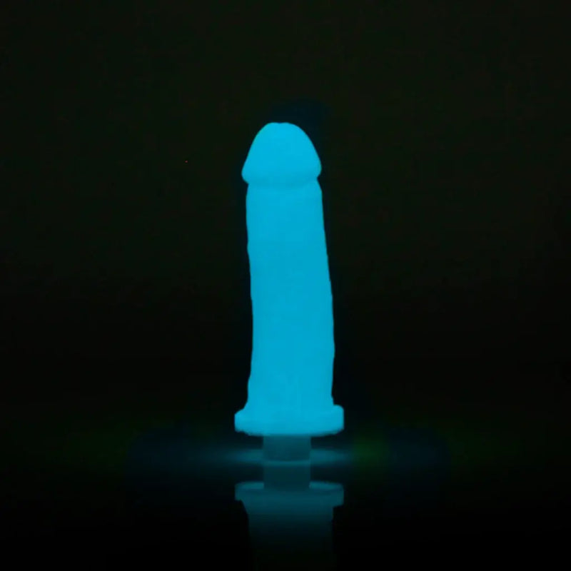 Clone-A-Willy Blue Glow in the Dark Vibrating Silicone Dildo Kit standing upright in a dimly lit environment