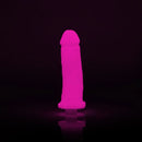 Clone-A-Willy Hot Pink Glow In The Dark Vibrating Silicone Dildo Kit illuminated against a black background.