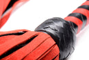 Isabella Sinclaire Black and Red Suede Flogger showcasing the detailed suede falls and braided handle.