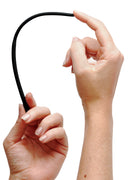 Hand holding the Isabella Sinclaire Silicone Urethral Sound Trainer Set showing its flexibility and softness.