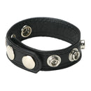 Black leather wrist cuff with metal snaps and studs, stylish and versatile accessory.