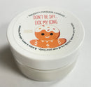 Don't Be Shy Lick My Icing Massage Candle Sugar Cookie in a white jar with a smiling gingerbread design.