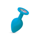 Gemma Clear Iridescent Gem Teal Silicone Butt Plug Medium showcasing a teal silicone body with a sparkling iridescent gemstone.