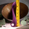 Evolved Lochness G Vibrator measured against a ruler showing off its arched shaft and ring handle for G-spot stimulation.
