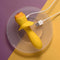 Selopa Mellow Yellow Vibrating Plug with USB charger on textured surface, showcasing its bold yellow design and heart-shaped gem control button.