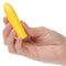 Hand holding Turbo Buzz™ Classic Mini Bullet Vibrator in vibrant yellow.