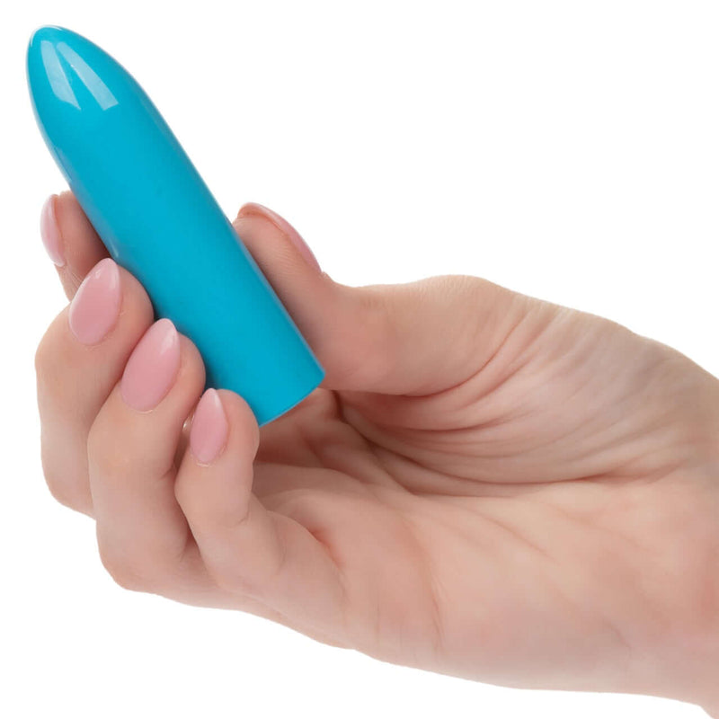 Hand holding blue Turbo Buzz™ Classic Mini Bullet with 10 functions of vibration, pulsation, and escalation for discreet and powerful pleasure.