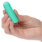 Compact green Turbo Buzz Round Mini Bullet vibrator held in hand for discreet pleasure with 10 functions, made of body-safe materials.