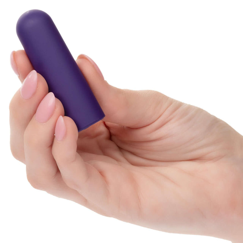 Hand holding Turbo Buzz™ Rounded Mini Bullet - Purple, a discreet and powerful 10-function vibrator.
