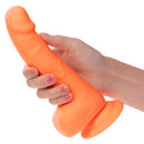 Hand holding Neon Silicone Studs 6 Inch Orange, lifelike and vibrant pleasure toy