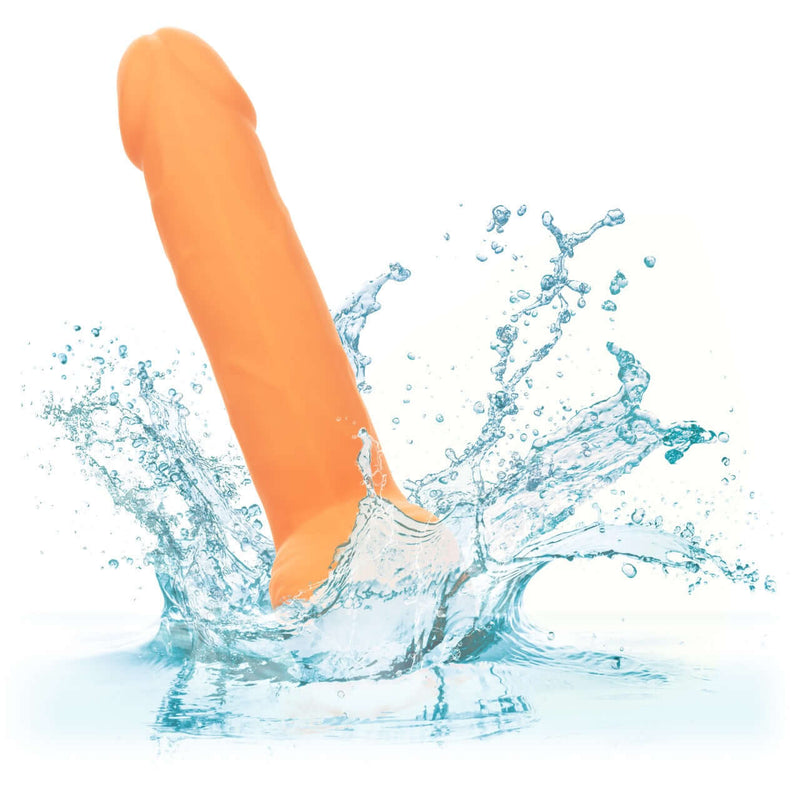 Neon Silicone Studs 6 Inch Orange pleasure toy splashing in water, vibrant and lifelike for sensational satisfaction.