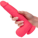 Rechargeable 7" silicone stud dildo with suction base held in hand showcasing lifelike detail and vibrant pink color.
