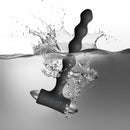 Petite Sensations Pearls Vibrating Anal Beads Black splashing in water, showcasing their sleek design and powerful vibration features.