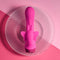 Selopa Butterfly Love powerful petite vibrator with curved shaft on a clear glass plate and pink background