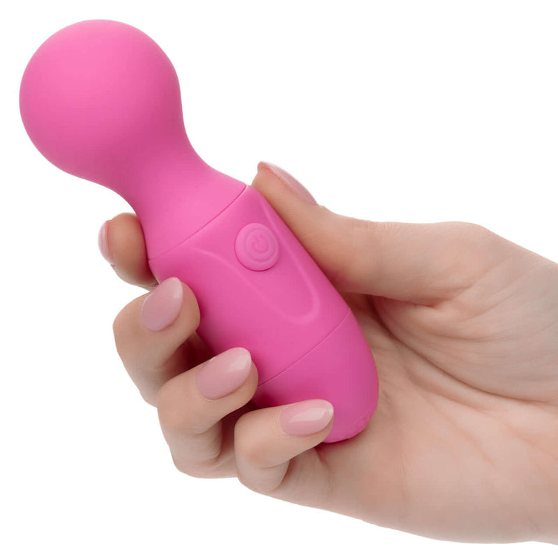 Hand holding pink First Time® Rechargeable Massager with flexible neck and power button