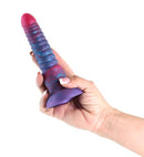 Hand holding a tri-colored silicone dildo, showcasing pink, blue, and purple colors, 6 inches in length.