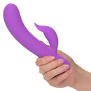 Purple First Time® Rechargeable Pleaser with dual stimulation being held, showcasing its ergonomic design and smooth texture.