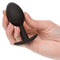 Hand holding a black Weighted Silicone Plug with ergonomic design for enhanced sensory pleasure