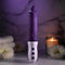 EVOLVED Plum Thrust powerful thrusting vibrator with realistic design and USB rechargeable, set against a serene candle-lit background.