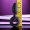 Evolved My Precious vibrating plug with ringed handle and tapered tip, measuring over 4 inches tall against a purple backdrop with a measuring ruler.