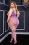 Purple off-the-shoulder bodystocking with intricate mesh and floral lace design, showcasing a bold and unique style in a stylish room.