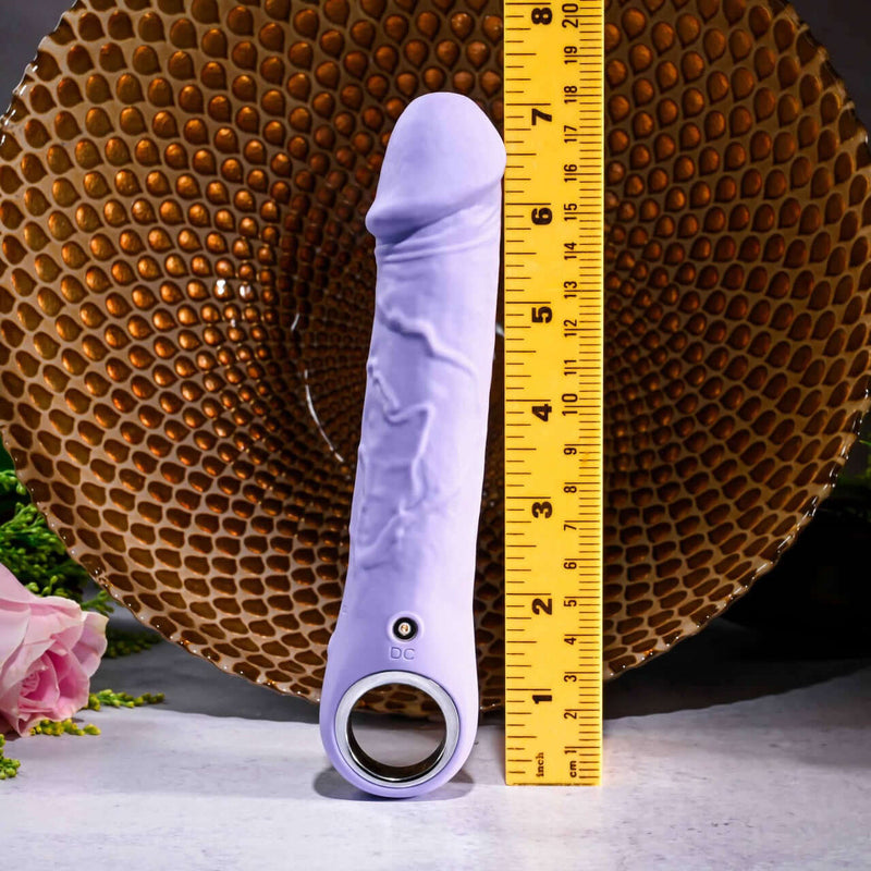 Evolved Purple Fantasy Vibrator with chrome-finished handle placed beside a ruler, showcasing its realistic design and multi-speed functionality.