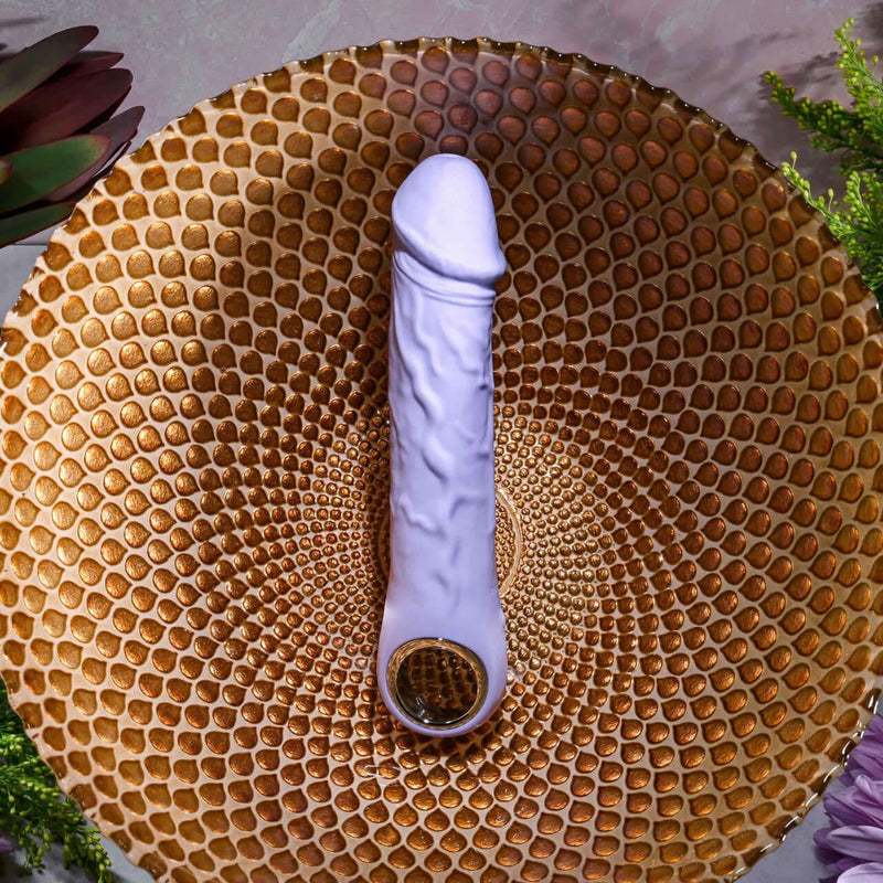Purple Fantasy Vibrator with chrome-finished ring handle on textured golden surface