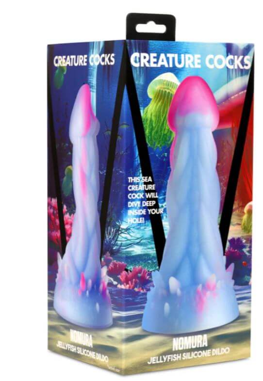 Creature Cocks Nomura Jellyfish Silicone Dildo in packaging, featuring a pale blue and pink design with a mushroom-shaped head and bumpy texture.
