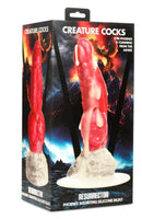 Creature Cocks Resurrector Phoenix Squirting Silicone Dildo in its packaging, showcasing its vibrant red and white colors.