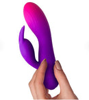 Glo-Girl Rabbit Vibrator Pink Purple held in hand showcasing its dual-motor design and soft silicone finish.