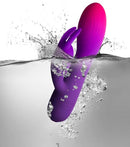 Glo-Girl Rabbit Vibrator Pink Purple submerged in water, showcasing its flexible design and vibrant colors.
