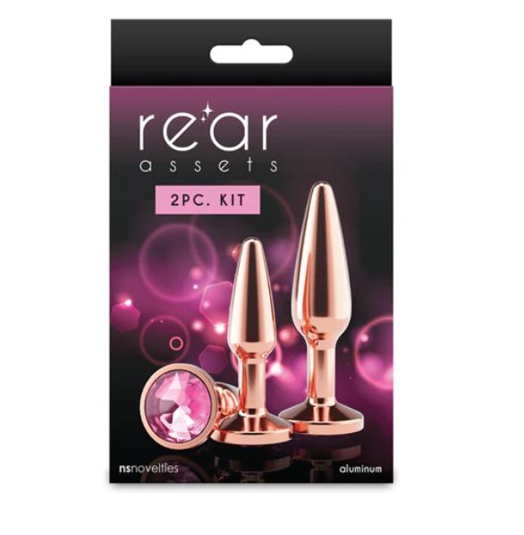 Rear Assets Tapered Trainer Chrome Plated Anal Plugs Kit Rose Gold in elegant packaging with a pink background.