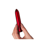 Poppy Red Rechargeable Bullet Vibrator held in hand, showcasing its sleek design and elegant color.